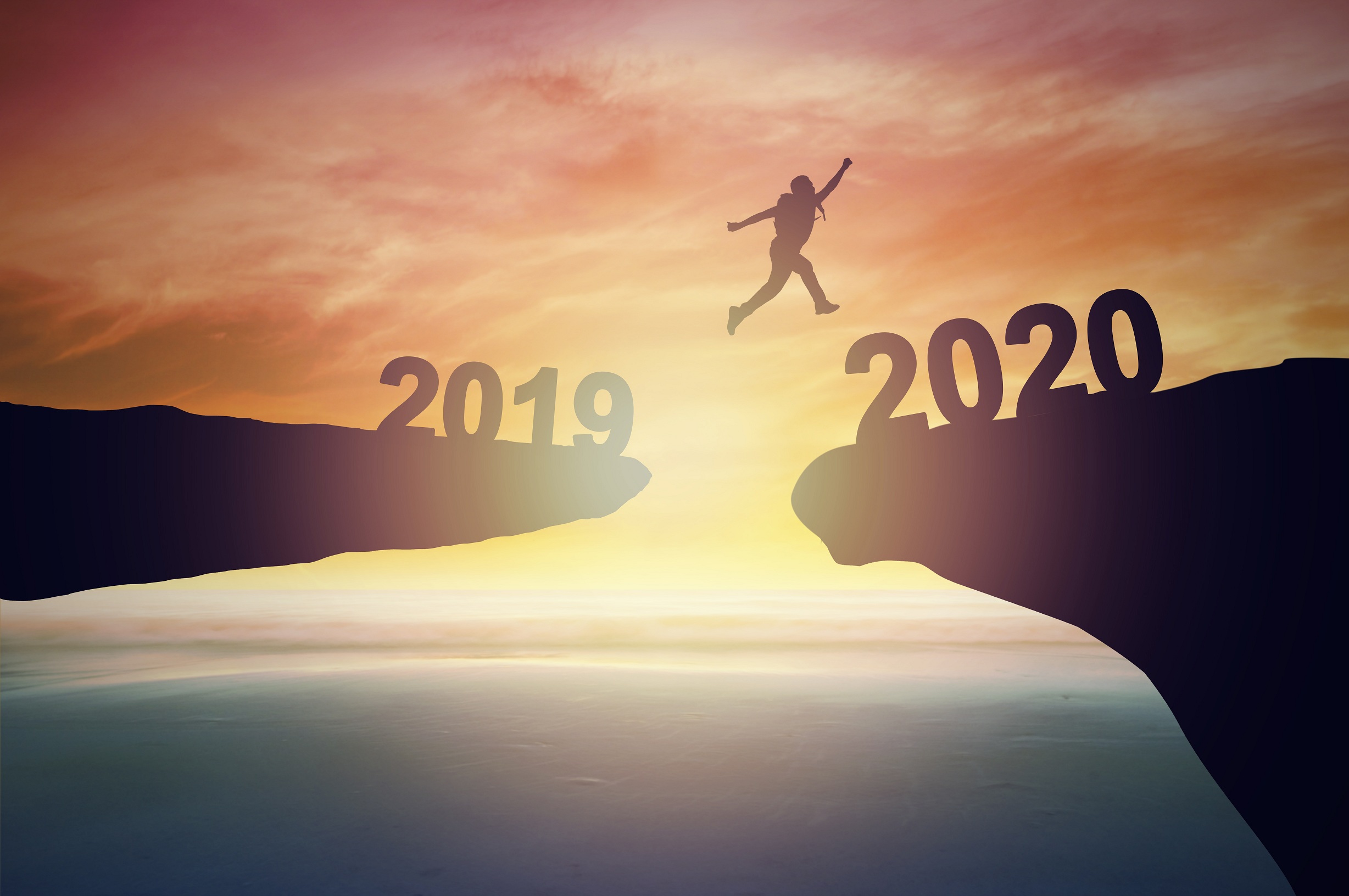 man jumping over barrier cliff and success from 2019 to 2020