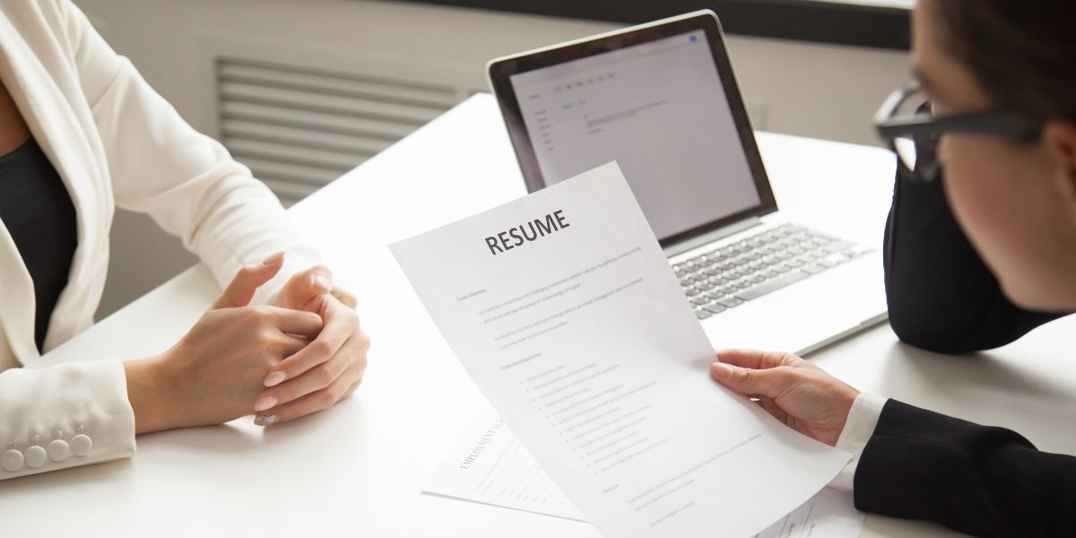 Recruitment agency employee checking resume to hire a candidate