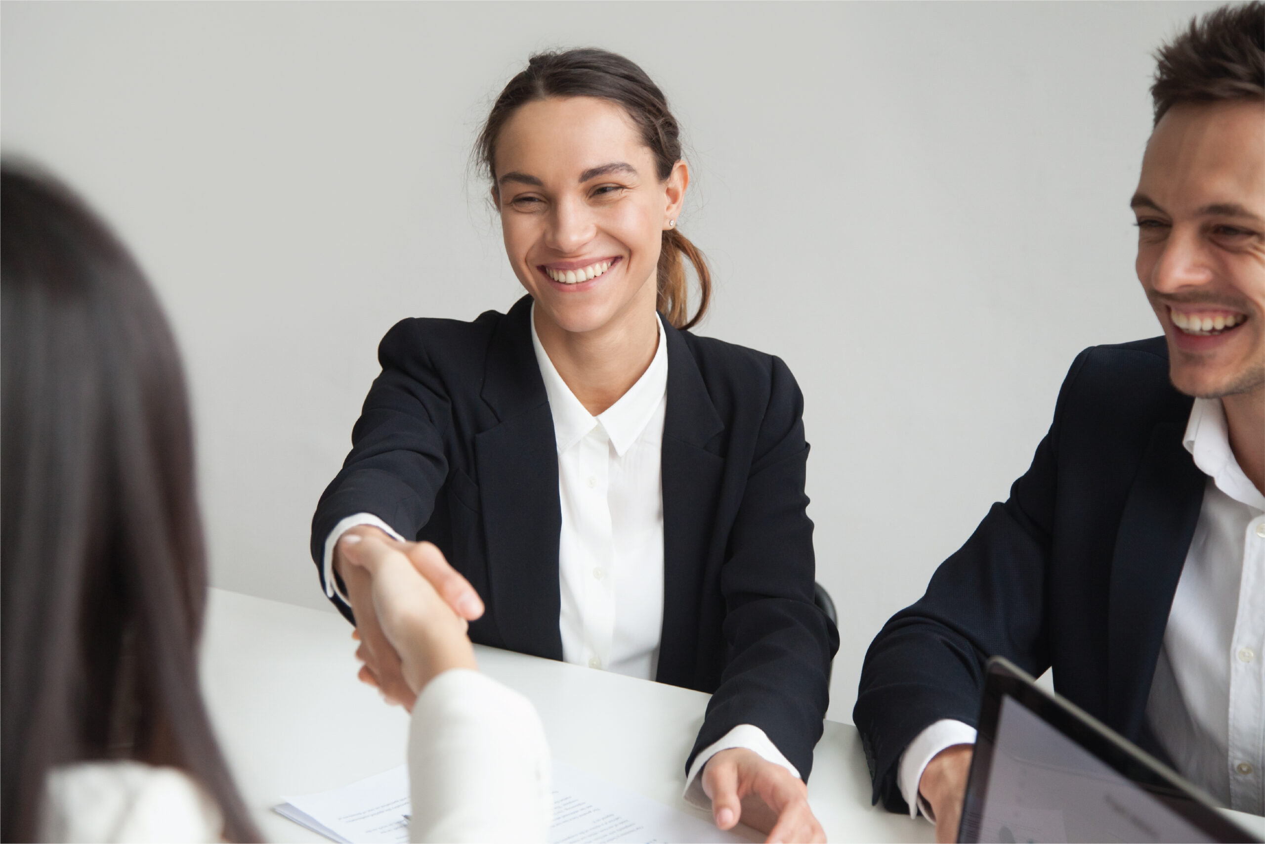 Happy candidate shaking hand with a recruitment agency employee